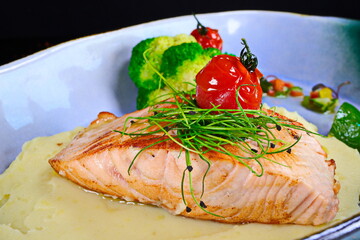 Grilled salmon fillet with mashed potatoes and vegetables on a plate - 619607370