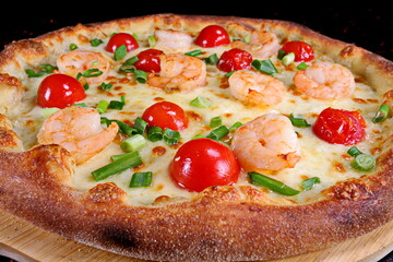 Pizza with shrimp, cherry tomatoes and green onions on a black background - 619607384