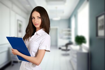 Young businesswoman hold clipboard in the office