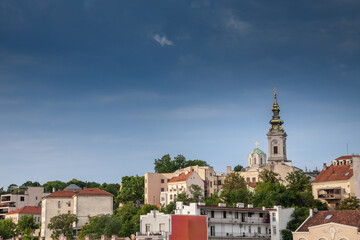 Fototapeta na wymiar Saint Michael Cathedral, also known as Saborna Crkva, with its iconic clocktower seen from a street of Stari Grad district. It is one of the main landmarks of Belgrade, Serbia.
