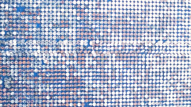 Silver mirror sequins sparkle and move in the wind, dynamic sparkling background