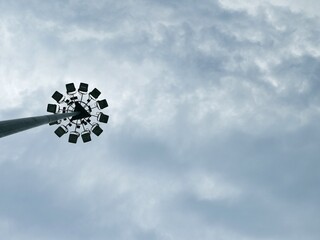 Street lighting pole isolated on blue sky background. Steel or metal illumination pole structure....