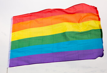LGBT flag against a cloudy sky close-up