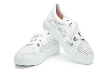 White female sneakers from perforated leather with thick laces isolated on white background.