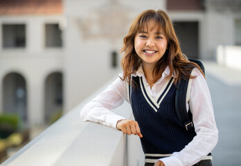 Portrait of young multiethnic Pacific Islander smiling student with backpack on college or university campus