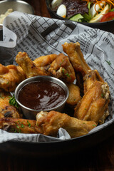 delicious plate of buffalo wings, with newspaper background
