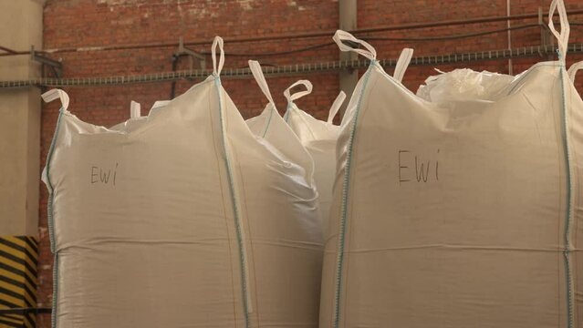 Industrial containers, Product packing, Bulk storage. Within industrial plant, extensive collection of bags contains products or raw materials.