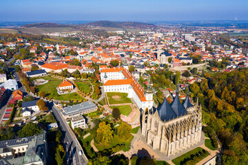 Fototapeta na wymiar Panoramic view from drone of Czech town of Kutna Hora overlooking medieval Jesuit College and St. Barbara Cathedral on sunny autumn day, Central Bohemian Region..