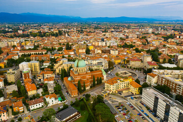 Fototapeta na wymiar Aerial view of Udine cityscape overlooking residential areas and ossuary temple of Fallen of Italy (Tempio ossario) in autumn day