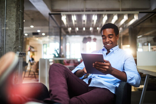 Young man using a digital tablet while working in a startup company office