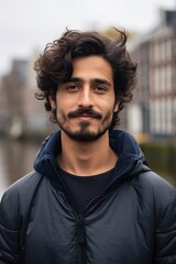 Young man of Arab origin in the city of Amsterdam. AI-generated image.