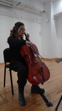 hispanic woman cellist performing a concert, latin female cello player, musician playing violoncello