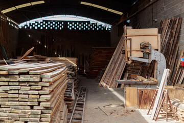 Fototapeta na wymiar Woodworking Haven: Overview of a Carpentry Workshop with Assorted Timber and Vintage Band Saw
