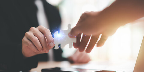 Businessman holding puzzle piece find business solution ,Connecting success and problem solution from creativity ,strategic planning to develop organization into future ,finding a business solution