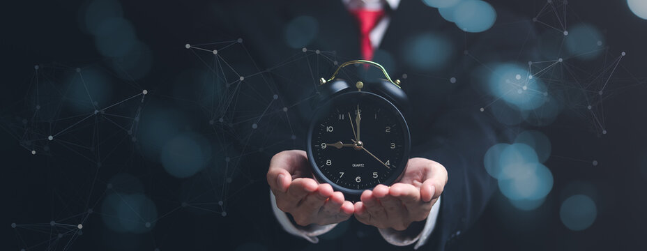 clock on businessman hand, time management concept ,effective business planning ,time management in organization ,Agreement and solution ,end of deal ,profitable use of time ,appointment punctuality