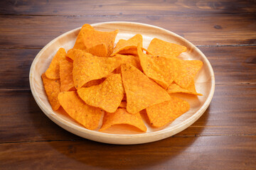Nachos in wooden plate on wooden background, Corn chips on wooden table.