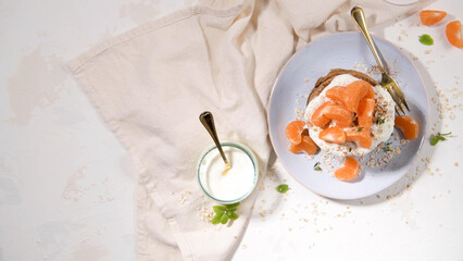 Pancakes with yogurt and tangerines