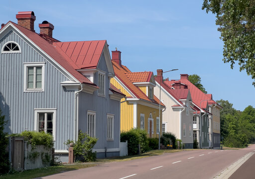 A row of quaint colorful houses on a quiet street in Mariehamn, &Aring;land Islands, Finland.