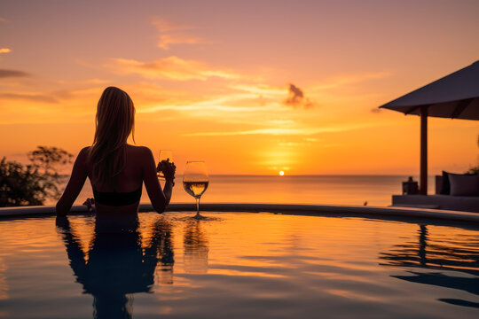 Woman watching the sunset with a cocktail in an infinity pool, showcasing luxury lifestyle, generative ai