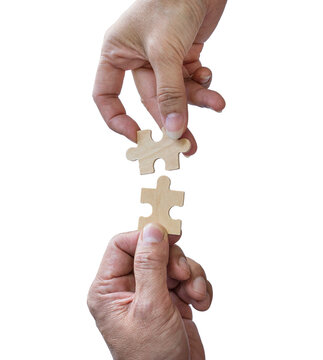 Two hands trying to connect puzzle pieces, isolated on transparent background.