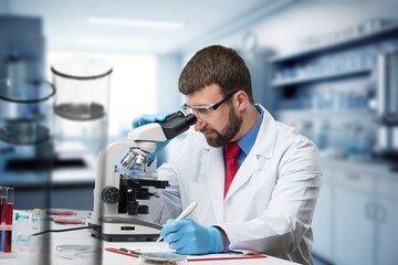 Smart man working in laboratory with microscope
