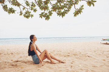 body woman sea beach sand sitting smile travel nature vacation freedom