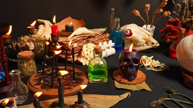 Magic liquid spell potion in the glass vials with black witchcraft candles. Mysterious witch fairy scene. Witch craft ritual background. Halloween holiday still life mystic background esoteric objects