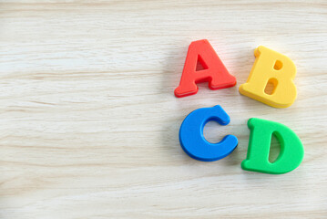 Education, learning and developement concept. Wooden alphabet of ABCD on a wooden background. Copy space.