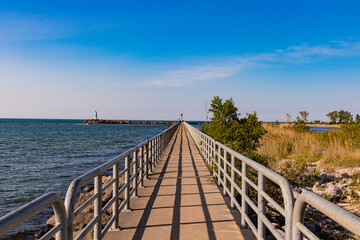 Center view of Boardwalk with metal railings centered down Lake Michigan 