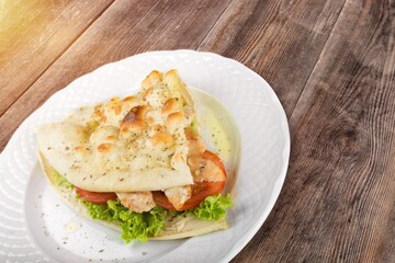 Fresh tasty sandwich with salad on plate