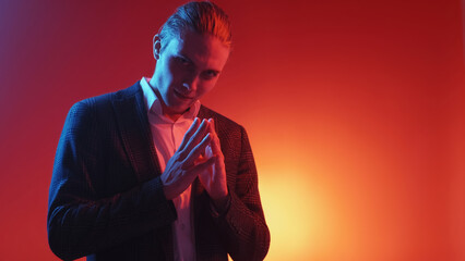Evil plan. Exciting expectation. Revenge intention. Red blue neon light tricky sly smirking man...