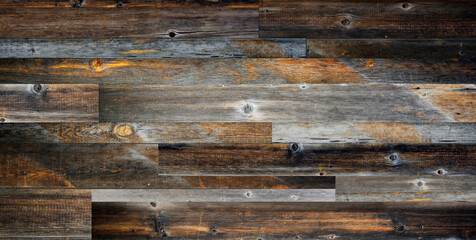 Dark stained reclaimed wood surface with aged boards lined up. Wooden floor planks with grain and texture.