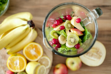 Healthy smoothie ingredients in blender bowl, top view. Various fruits , vegetables and berries....