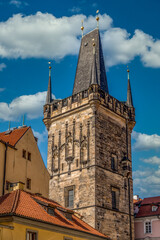 Fototapeta na wymiar Lesser Town Bridge Tower at the end of the Charles bridge in Prague with cloudy blue sky