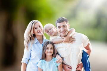 Happy young family play together at park