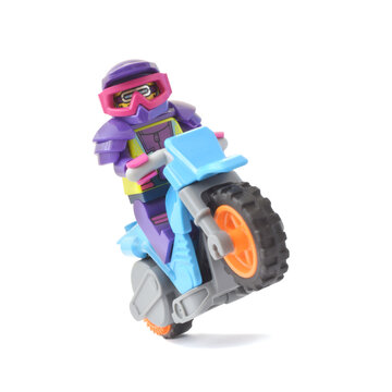 Editorial illustrative image of lego minifugure of biker on motorbike isolated on white. Popular children toy with plastic bricks.