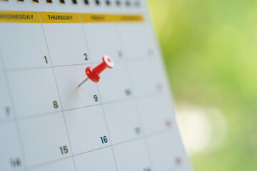 Red pin on the 9th day on the calendar with copy space.