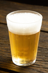 beer glass on wooden table . american cup, soviet glass