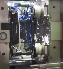 Close up plastic injection molding machine.