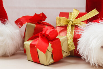 Obraz na płótnie Canvas Holidays, present, christmas concept. Small red and golden boxes with gifts tied bows