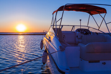 Naklejka na ściany i meble Yacht near the pier against sunset, summer vacation concept