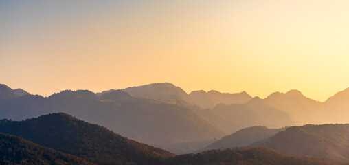 Fototapeta na wymiar Mountain peak with in sunset sky, panoramic mountain range in sunset light.