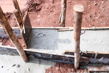 Pouring cement in the formwork to build a beam to build a wall, construction work