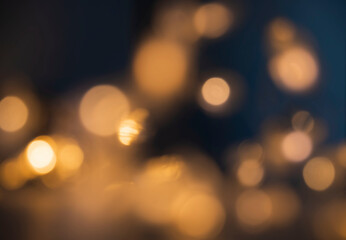 Abstract golden bokeh lights glowing in the dark