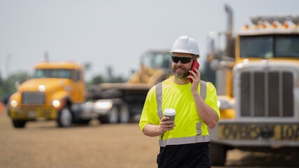 caucasian construction manager. mature architect in construction area. construction site with worker hold coffee at break. Builder discussing construction project on phone
