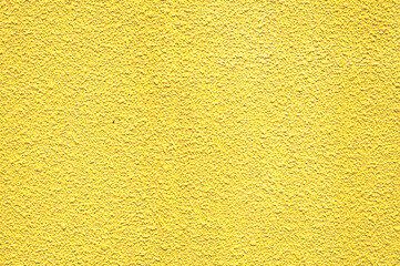 ざらざらした黄色い壁のバックグラウンドテクスチャ