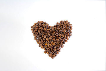 coffee beans folded into a heart on a white background