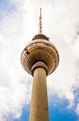 The TV Tower located on the Alexanderplatz in Berlin, Germany. White and blue sky in the backgroud.
