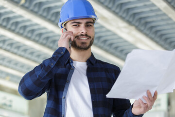 architect inside house being renovated talking on cellphone