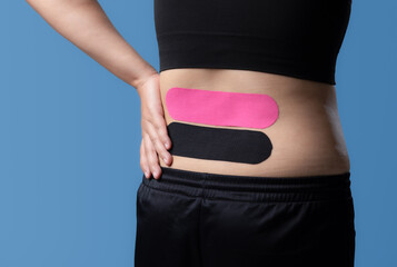 Kinesiological tape pink and black,muscle tape on human back,Taping problem areas and pain relief